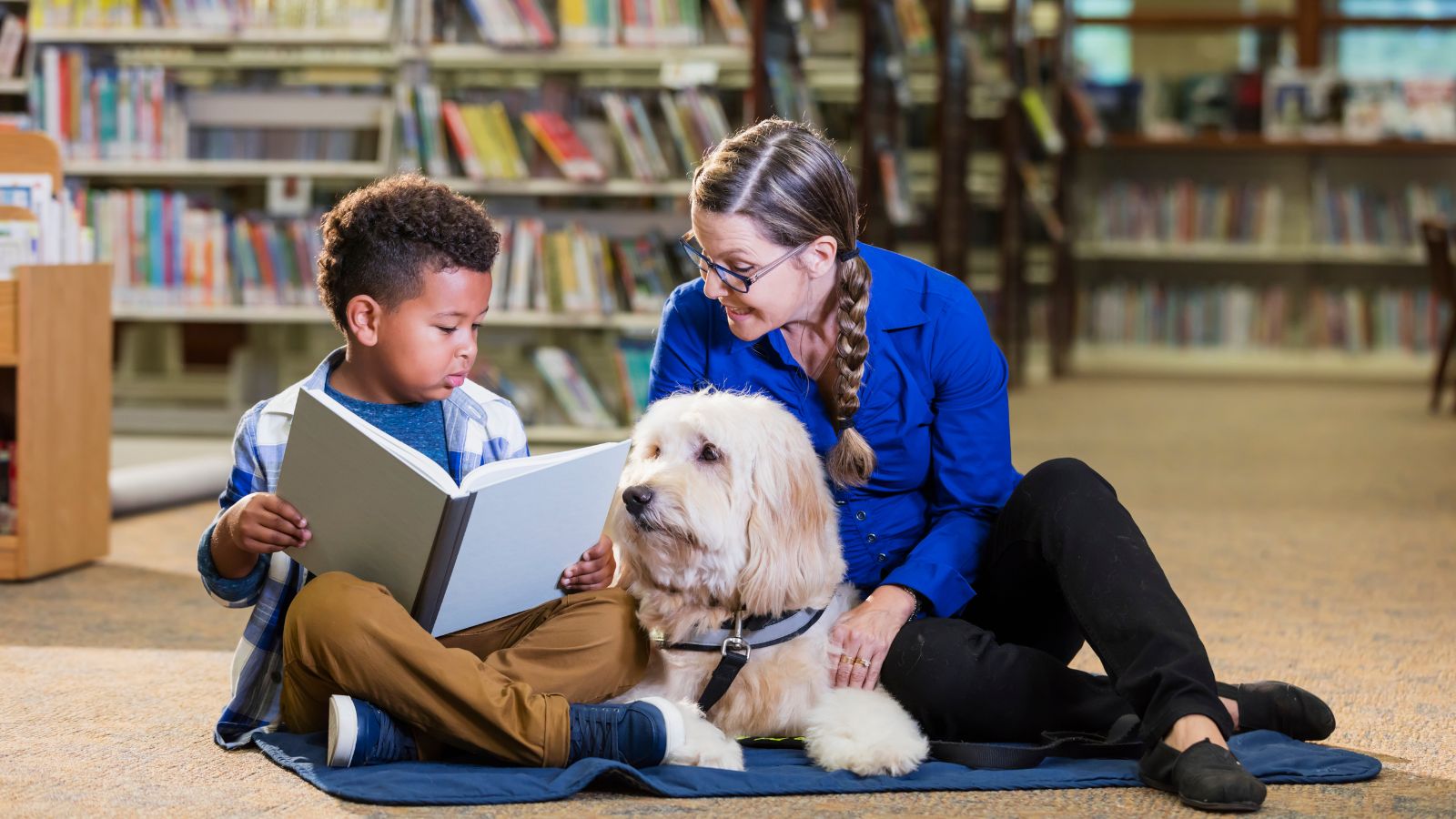 Child Reading With A Dog