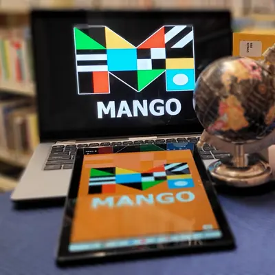laptop and tablet with globe and language learning books
