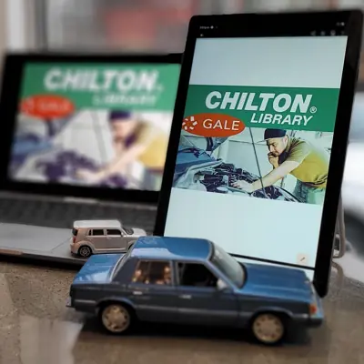laptop and tablet with die-cast cars