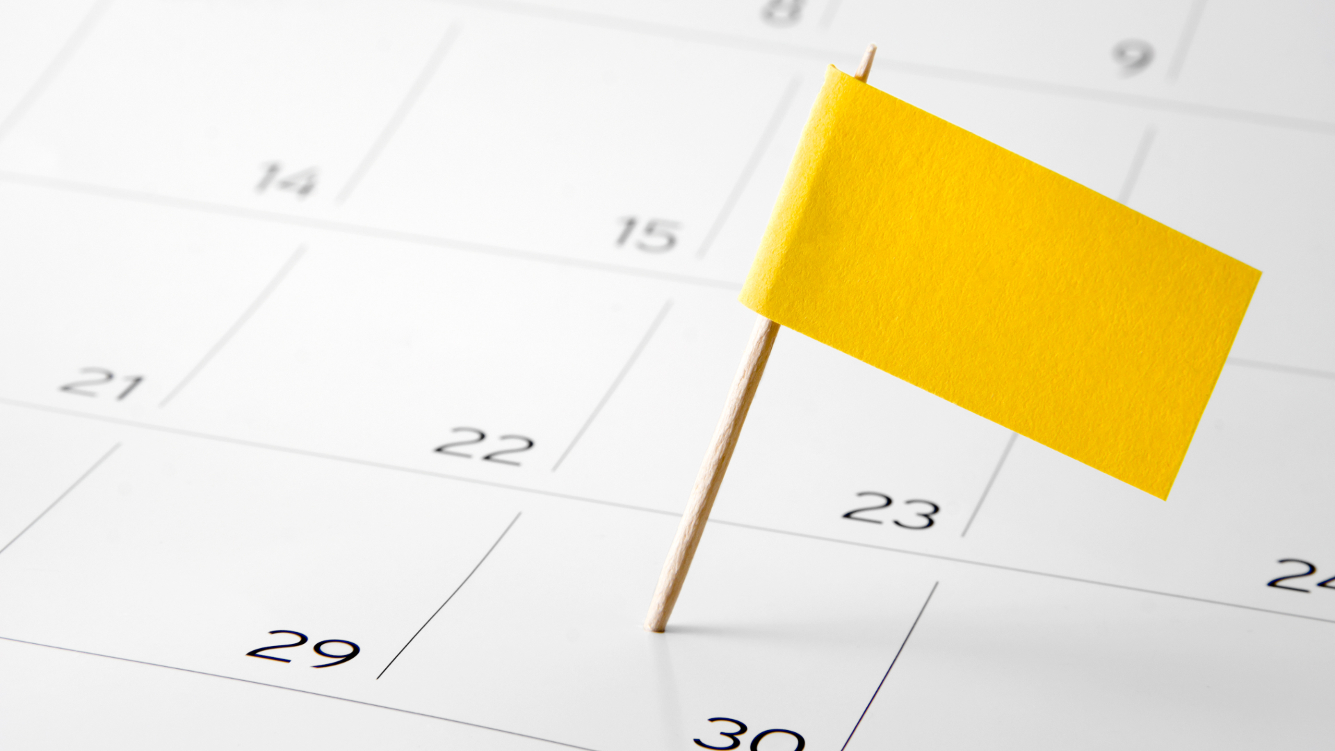 Calendar with a yellow flag pin